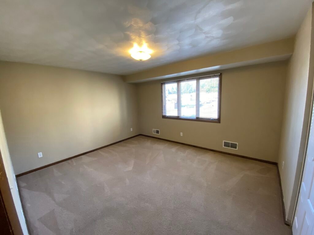 Spacious bedroom in a two-bedroom Garden Apartment at Country Club Hills, Steubenville, with closet space.