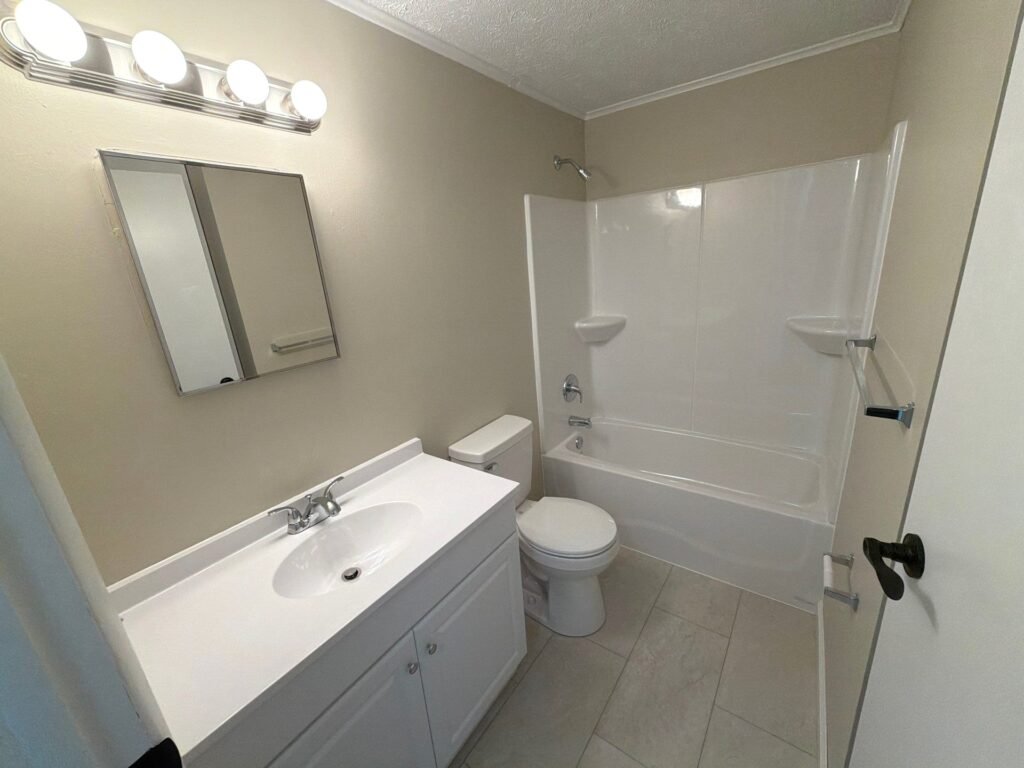 Full bathroom inside a one-bedroom Patio Home at Country Club Hills, Steubenville, with vanity and fixtures