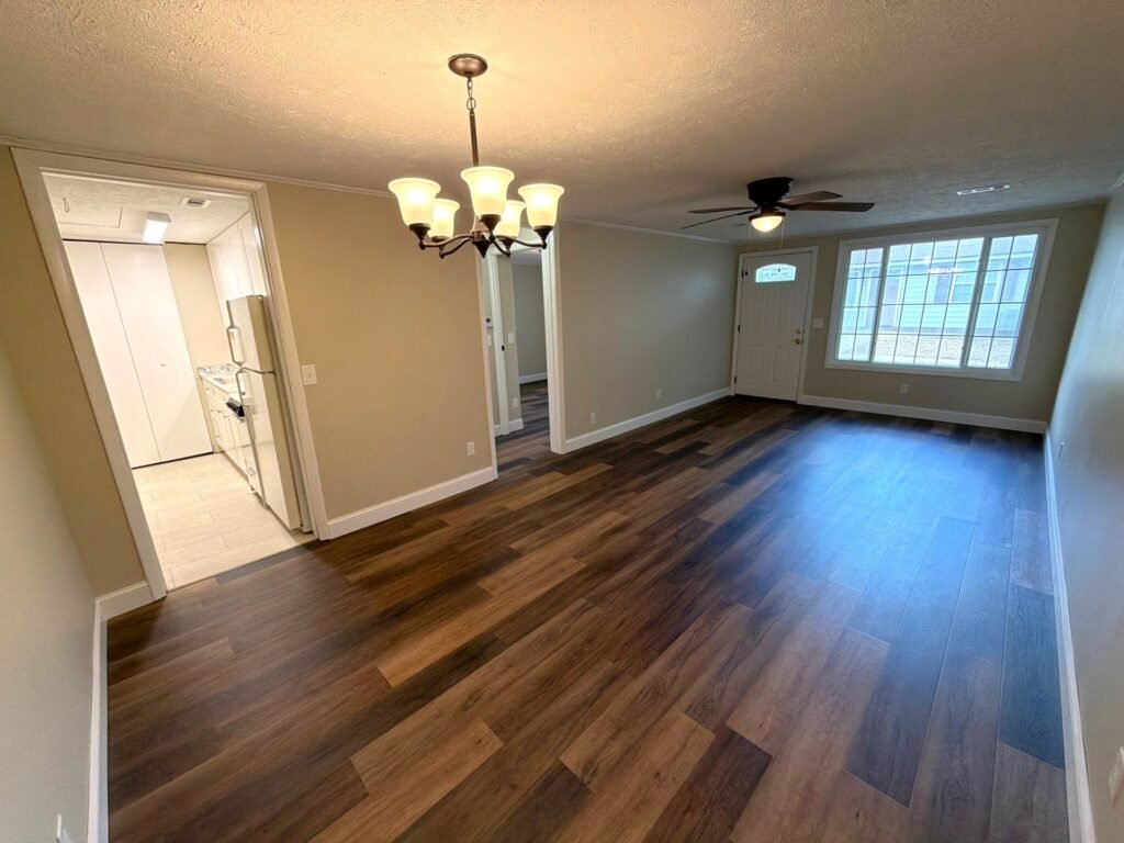 Open dining and living room layout in a one-bedroom Patio Home apartment at Country Club Hills, Steubenville, viewed from the dining space