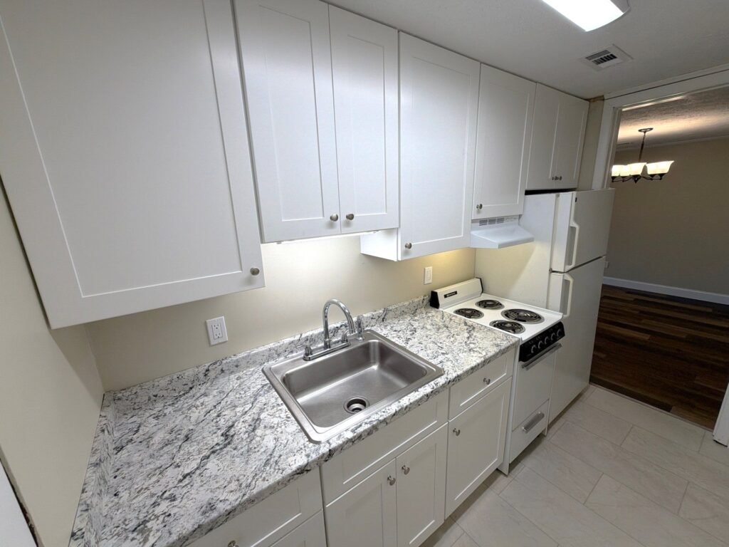 First view of the kitchen in a one-bedroom Patio Home at Country Club Hills, Steubenville, with appliances and cabinetry.