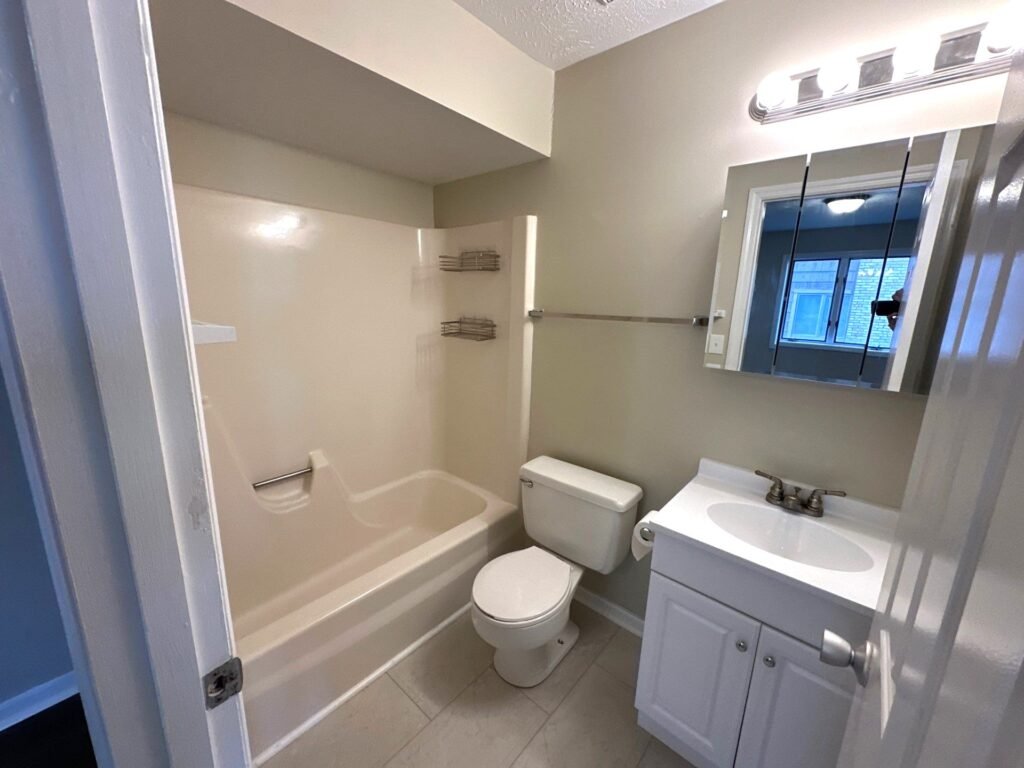 Full bathroom in a one-bedroom Garden Apartment at Country Club Hills, Steubenville, with vanity and fixtures.