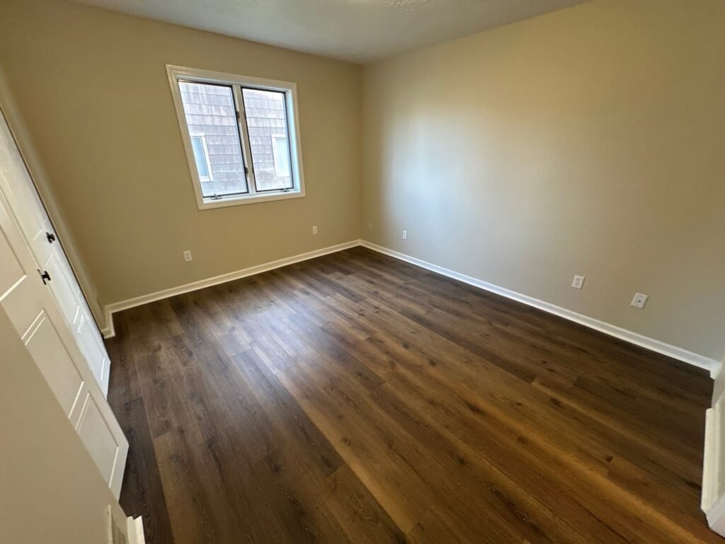 Spacious bedroom in a one-bedroom Garden Apartment at Country Club Hills, Steubenville, with closet space.