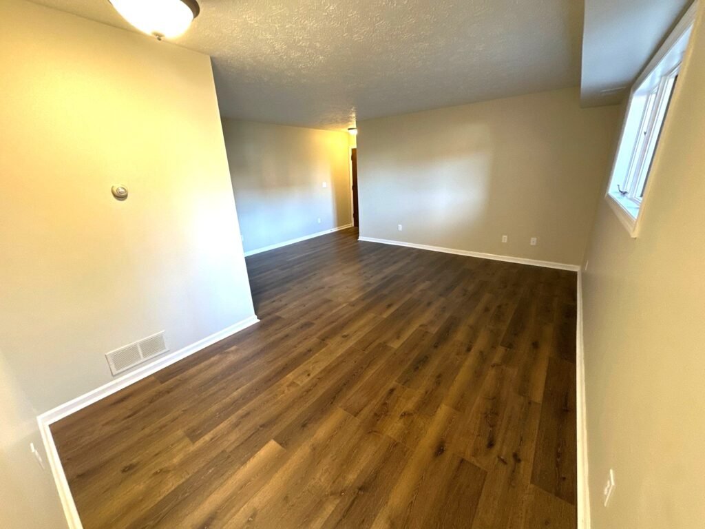 Open layout in a Garden Apartment at Country Club Hills, Steubenville, showing view from dining area into living room.
