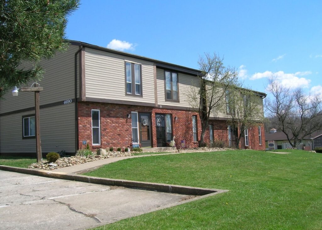 Front exterior view of the Scioto Townhouses at Country Club Hills in Steubenville, with landscaped grounds and private entrances.