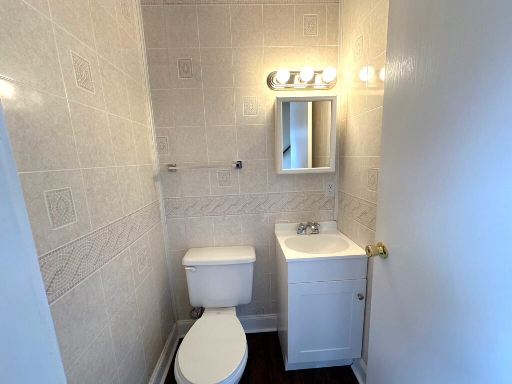 Main floor half bath inside a Scioto Townhouse at Country Club Hills in Steubenville with sink and vanity