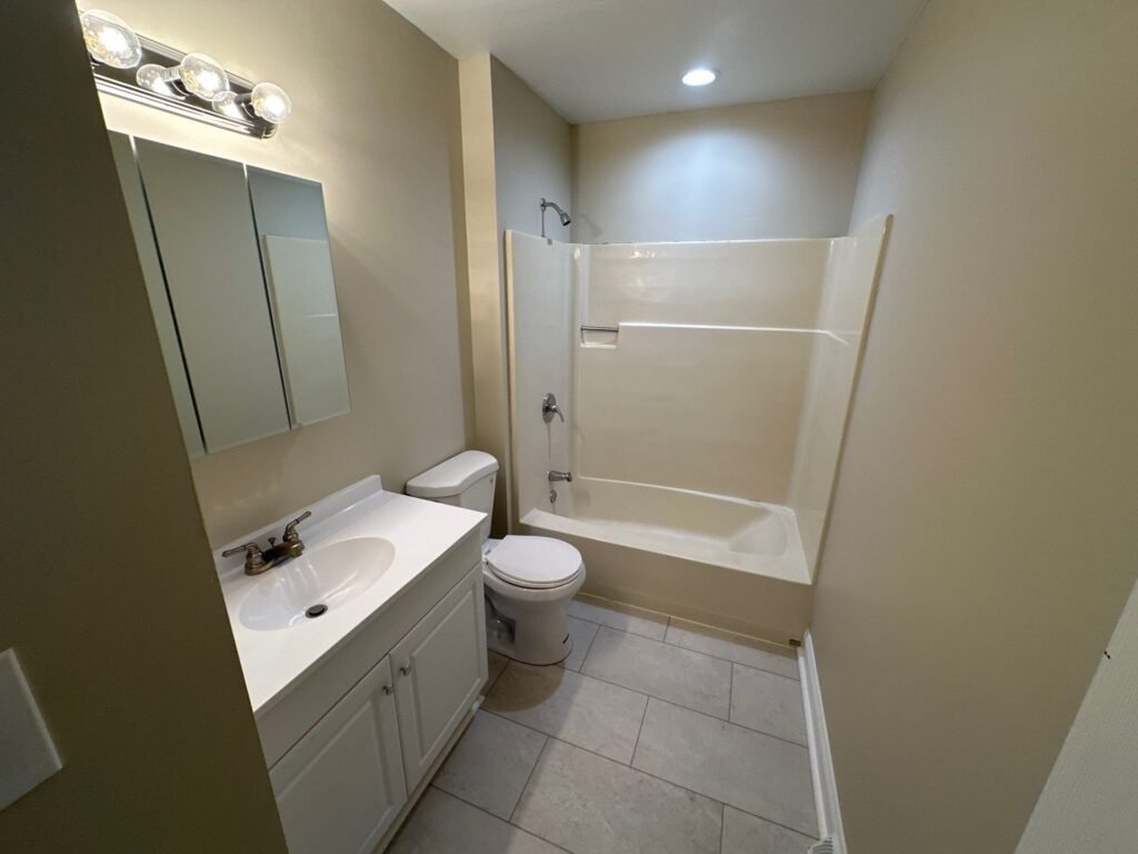 Full main bathroom inside a Scioto Townhouse at Country Club Hills in Steubenville with vanity and fixtures